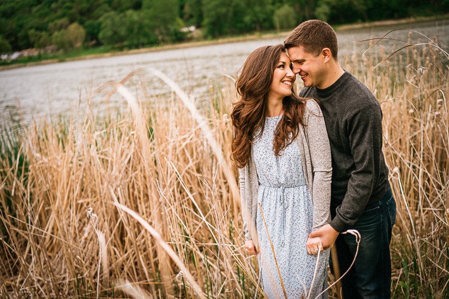 Couple in tall grasses by lake