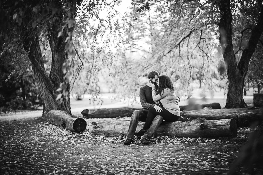 Black and white of couple sitting on logs