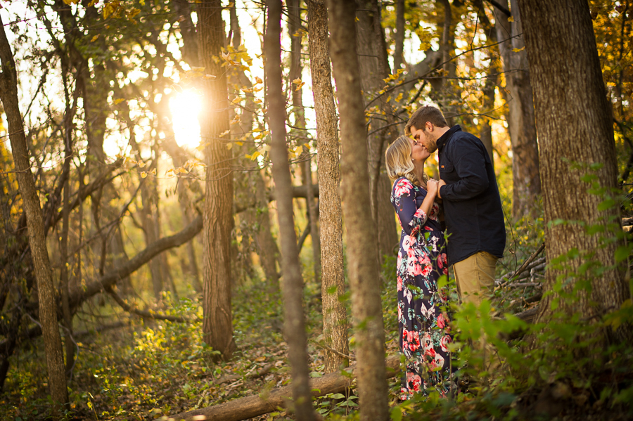 Couple in woods with sunlight filtering